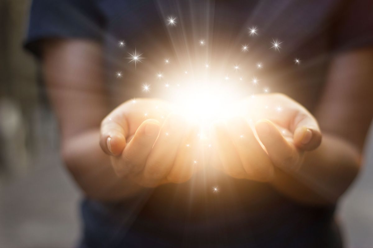 Hands holding magical miracle starburst