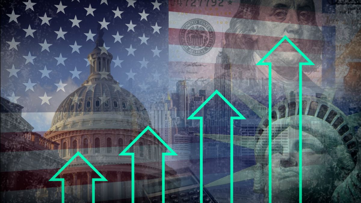 Illustration of the United States under construction, with a worker in a hard hat using a laptop over a U.S. map labeled “Under Reconstruction,” symbolizing government economic intervention and stimulus.