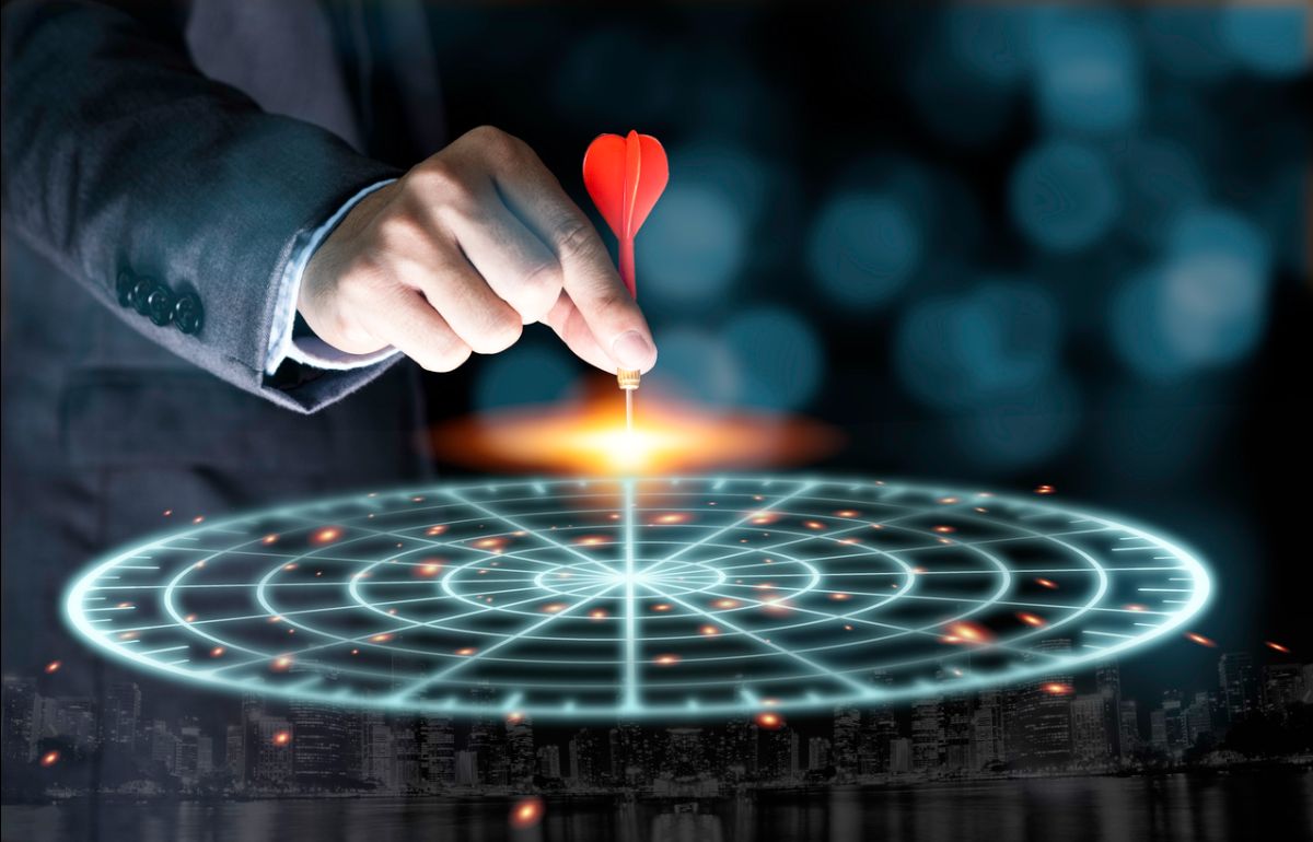 Businessperson placing a dart at the center of a glowing target, symbolizing strategic competition and focused investment decisions in global commodity markets.