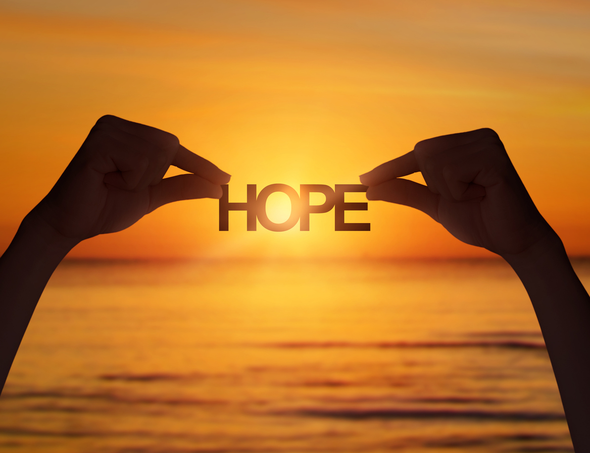 Image of two hands holding the word hope